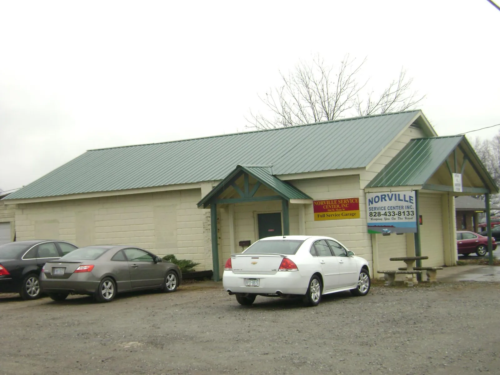 Green metal roof on a service garage with a covered entry in Roberts